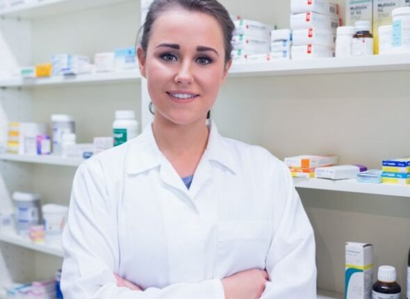 Premium Photo _ Portrait of a smiling student in lab coat with arms crossed